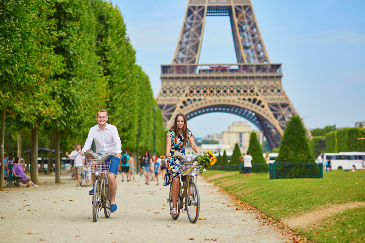 Couple cycle near Eiffel Tower Paris